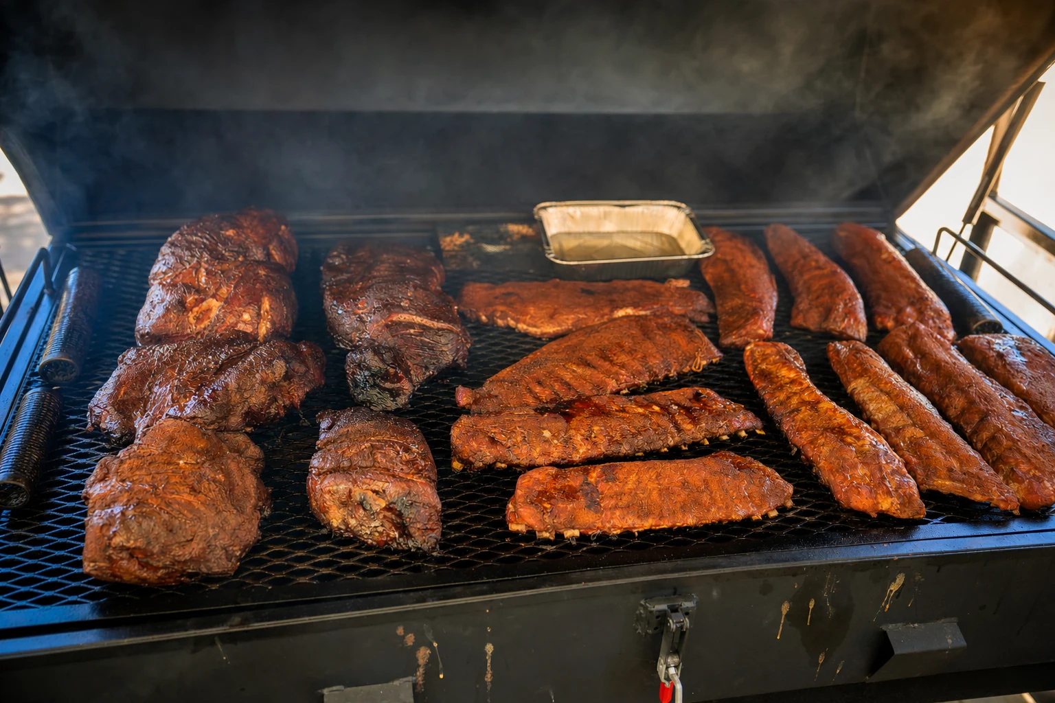 Ribs and smoked sausage on the smoker grates